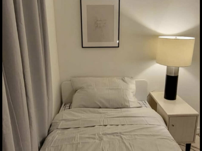 Cozy bedroom with huge locker and a beautiful study table and cozy lampshade 