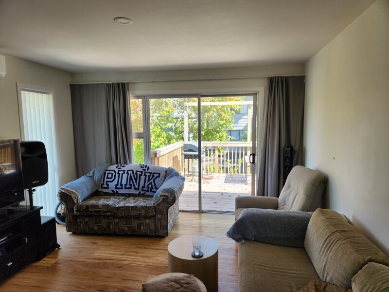 Contemporary kitchen equipped with a dishwasher, microwave, fridge, and electric cooktop Bright, sun-filled deck Laundry area with washing machine Extra storage room available close to bus stop and shop