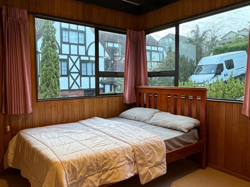 A fully furnished private room with a queen-sized bed, including fresh bed sheets and a co