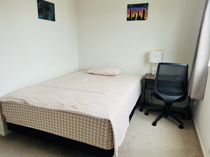 Bedroom with a Queen size bed, study table and a comfortable chair
